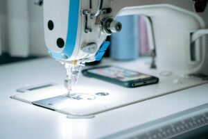 Focused view of an industrial sewing machine with attention to detail, ideal for tailoring themes.